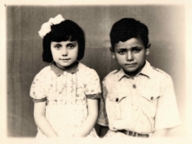 Black and 
   white formal shot of Henryka and Jan Holeder. Henryka has a white ribbon in her very dark hair. Both trying to smile