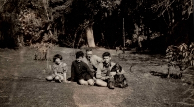 Garden shot of Bill behind the three children. Joseph has his arms around the spaniel