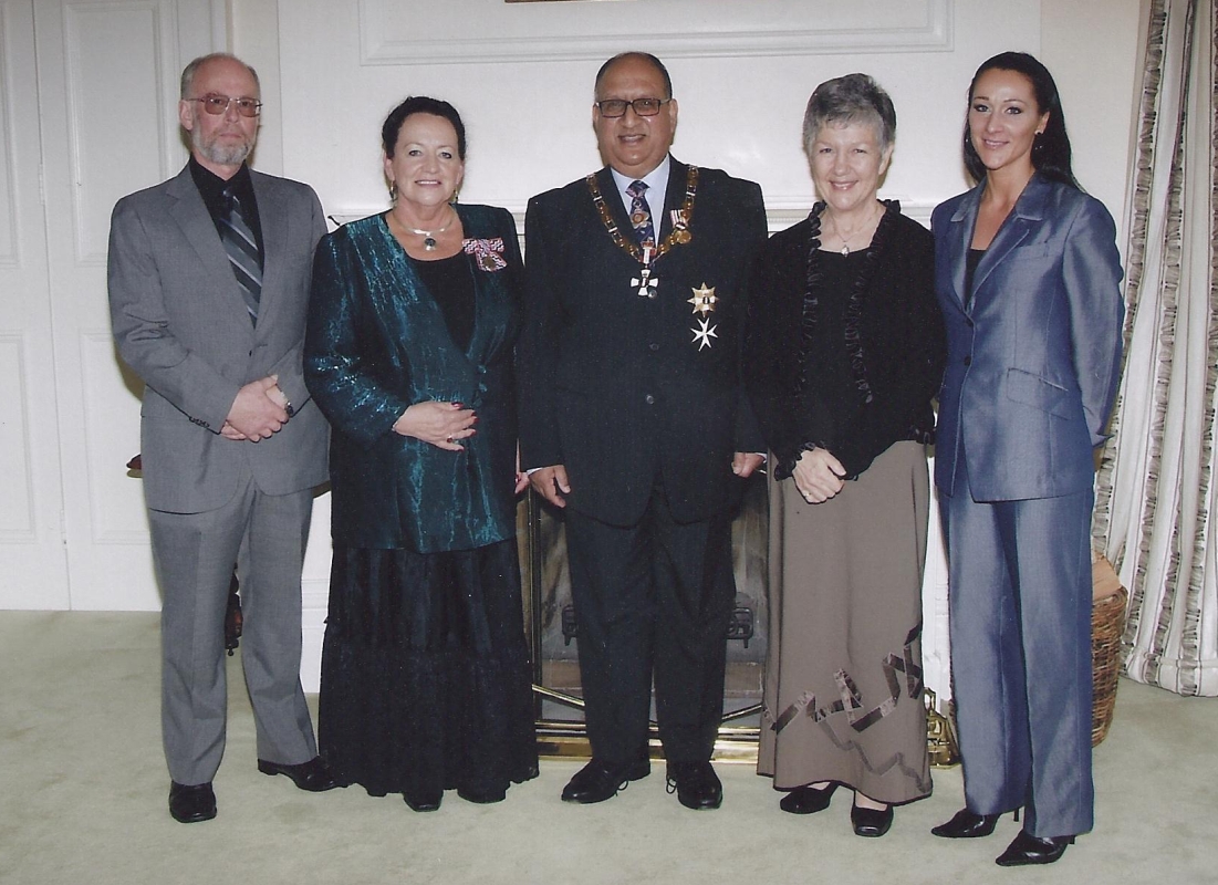 Carol's 
after-award photograph with people described in the caption below.