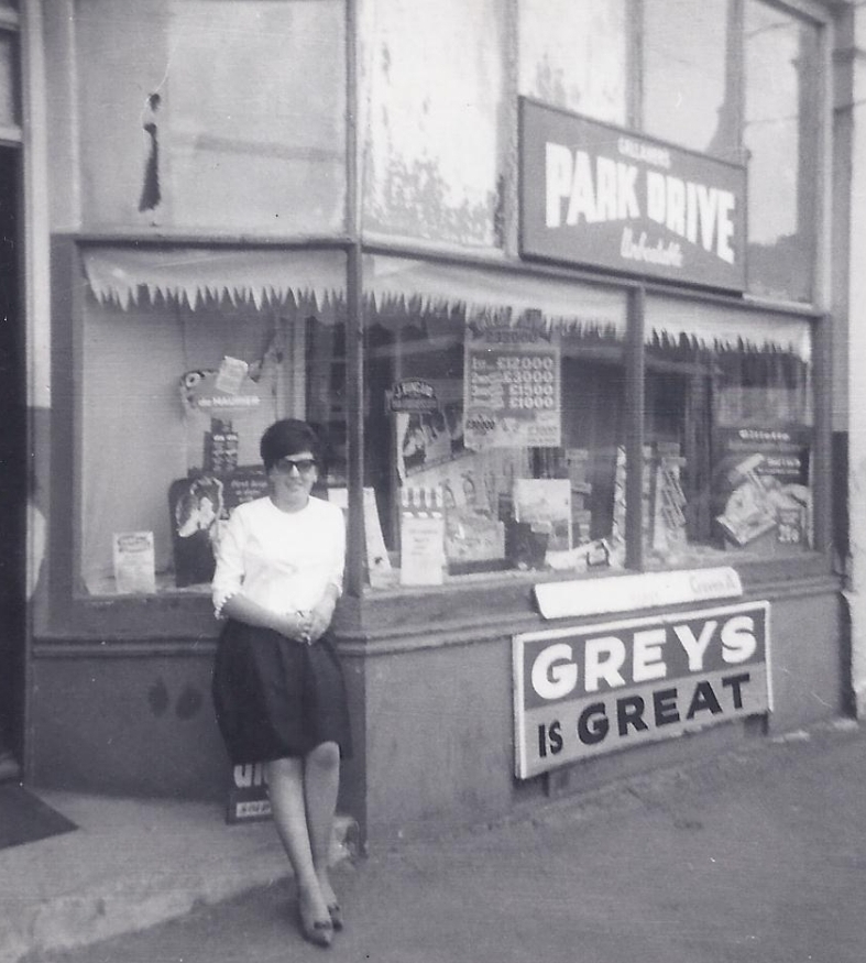 Carol, aged about 16 outside her dad's shop.