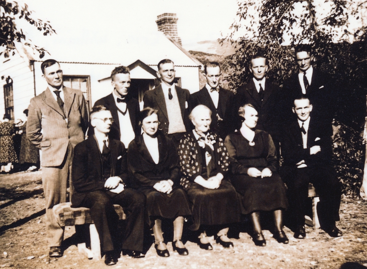 Family group 
in a garden, two rows sitting and standing.