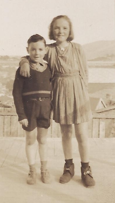 Yvonne, about 11, 
has her arm around Roy, about 8