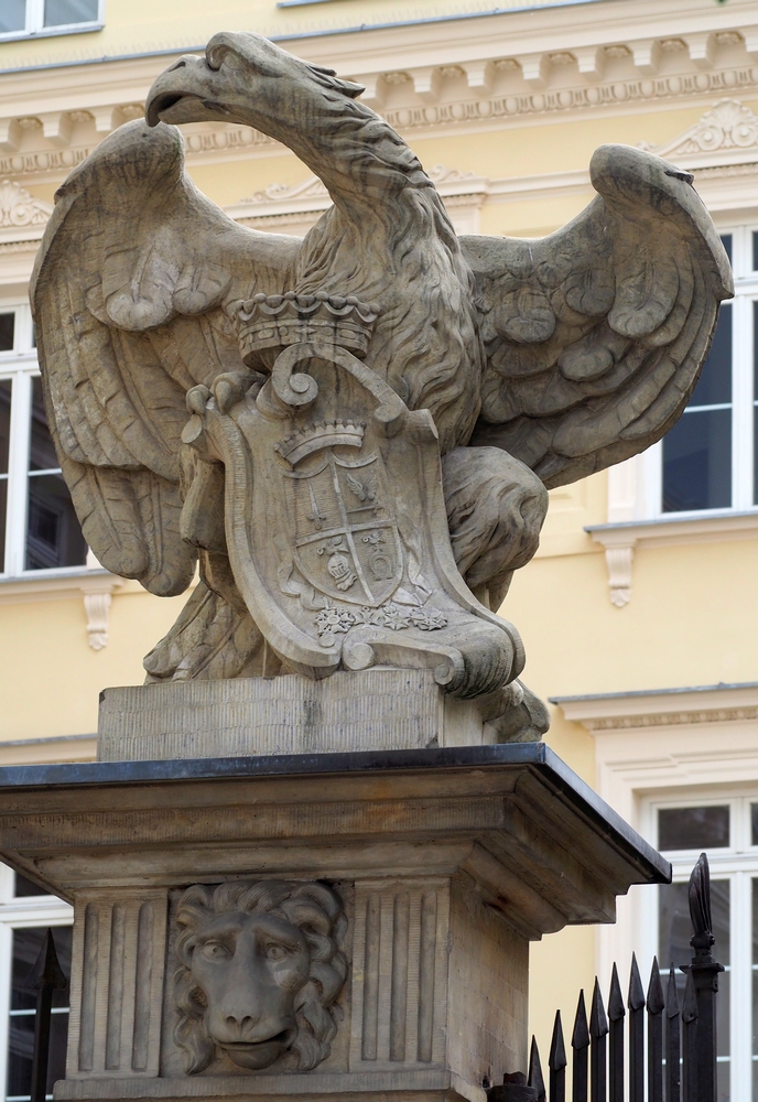 a striking, 
lop-sided stone sculpture of a white eagle cradling ae Polish coat of arms