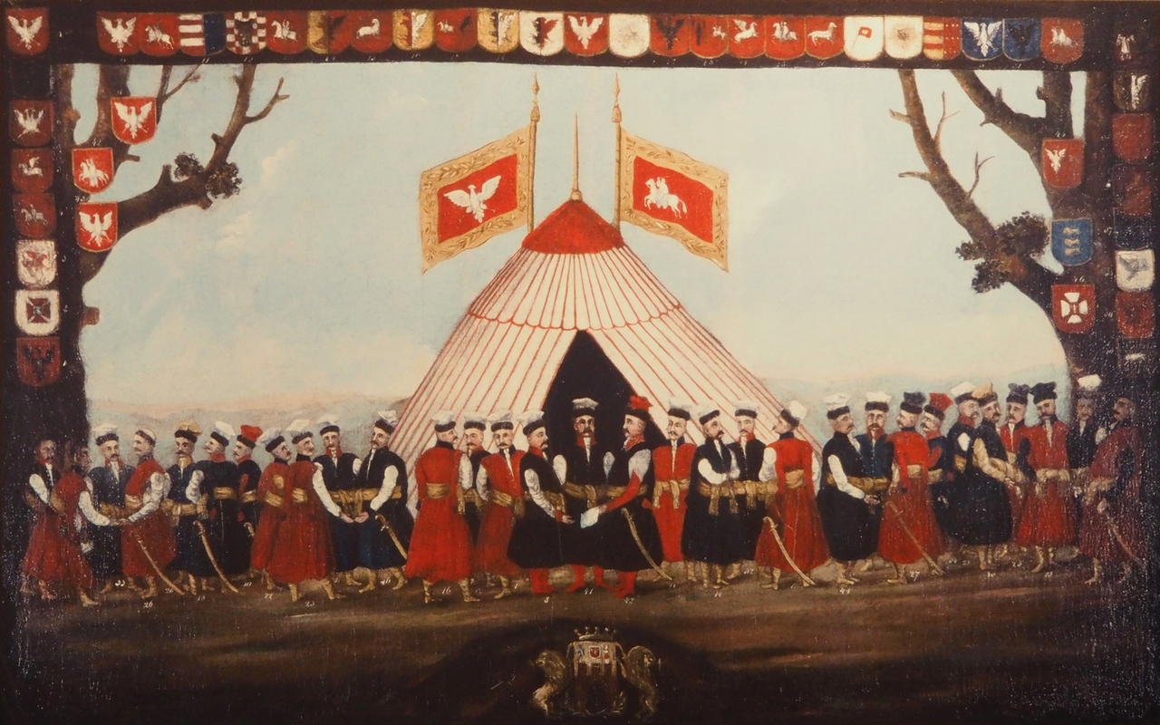 A naive painting of 31 men 
in a field in front of a tent with two flags bearing the national emblems of POland and Lithuania. The painting is surrounded 
by the heraldry of those depicted.