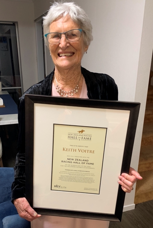 Faye, 
   with a lovely smile, holding the framed certificate after the function.