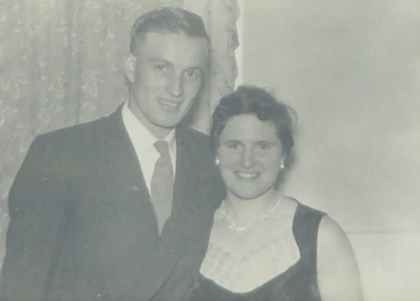 A sepia 
   top-of-bodies shot of Faye and Barry in formal attire.