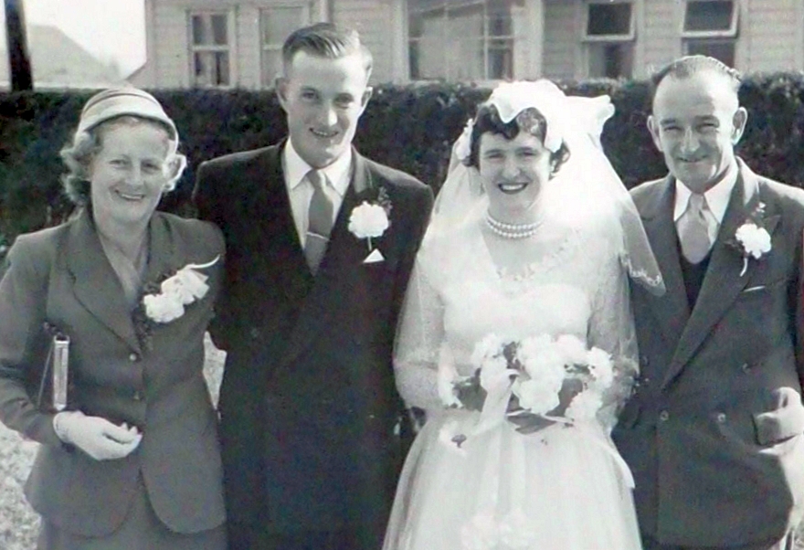 The 
   newlyweds flanked by an older man and woman.