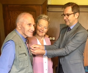 Bronek being presented  his medal by the Polish Ambassador. Ela in the middle looks on at Bronek.