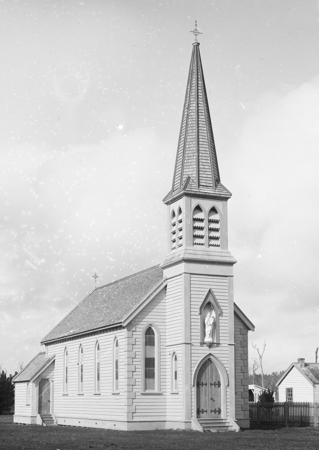 a black and 
white photograph of the original church, with its elegant spire and inset statue of Our Lady above the doorway