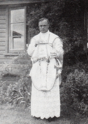 black and white 
full-length shot of Fr Wilniewczyc in Mass attire