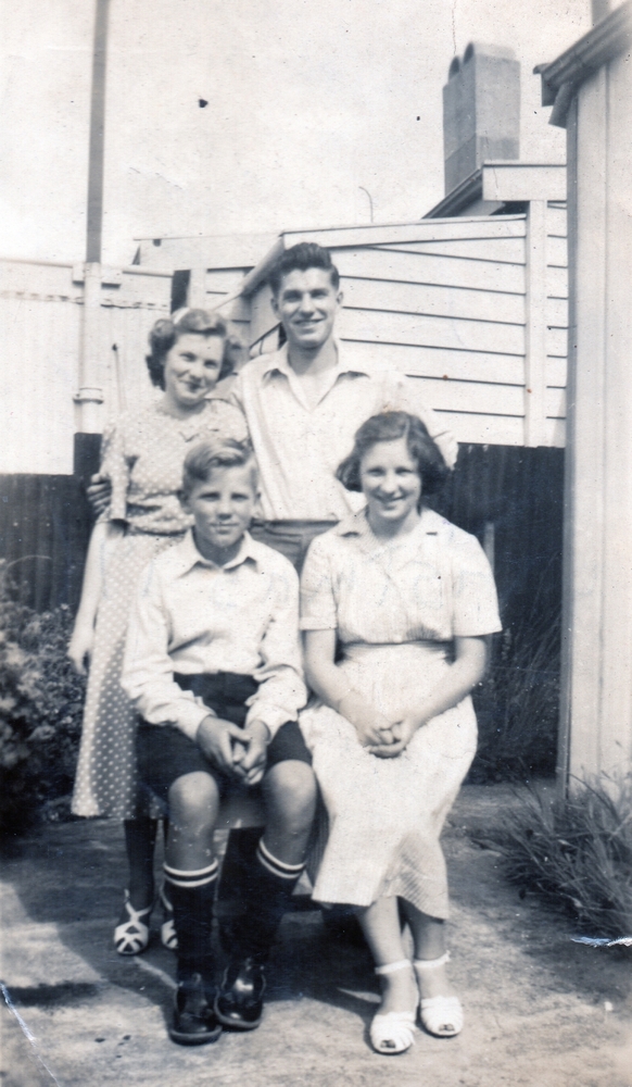 A happy photograph of the 
siblings, two sitting, two standing in the yard. Czesław has his arm around Zofia, who is leaning her head towards him. 
Zdzisław is in school uniform.