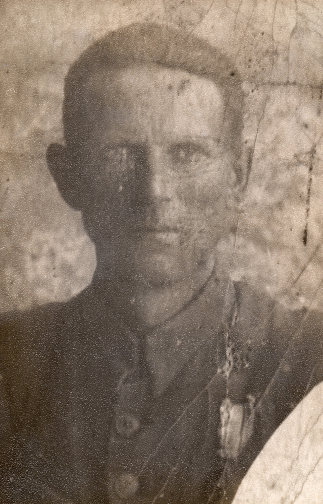 A blurred sepia head and 
shoulders photograph of Władysław in a buttoned military uniform. The award on his left breast seems to have been scratched 
out.