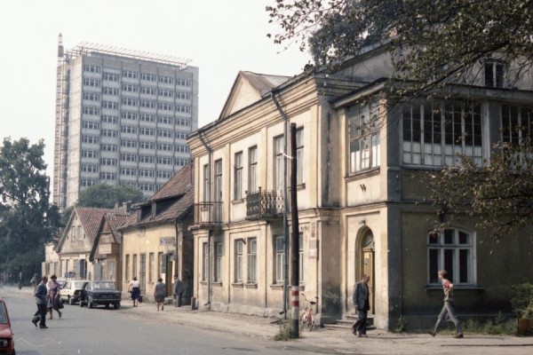 Street in 
Białystok with old houses and apartment block in background