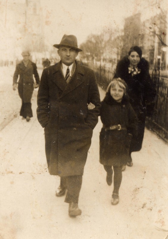 Stanisław Jarka 
striding along a street in Białystok with his daughter, Jadzia.