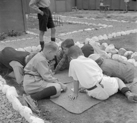 Polish boys 
playing a floor game outside