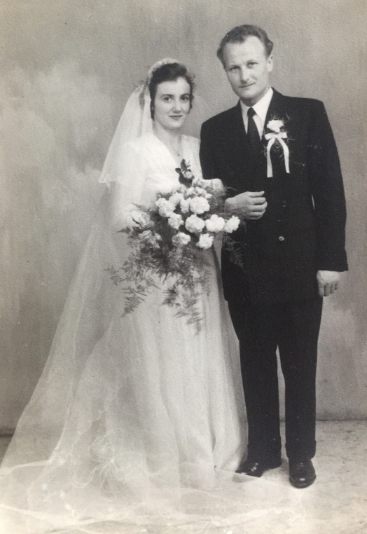 Joanna and 
Tadeusz pose in their wedding attire.