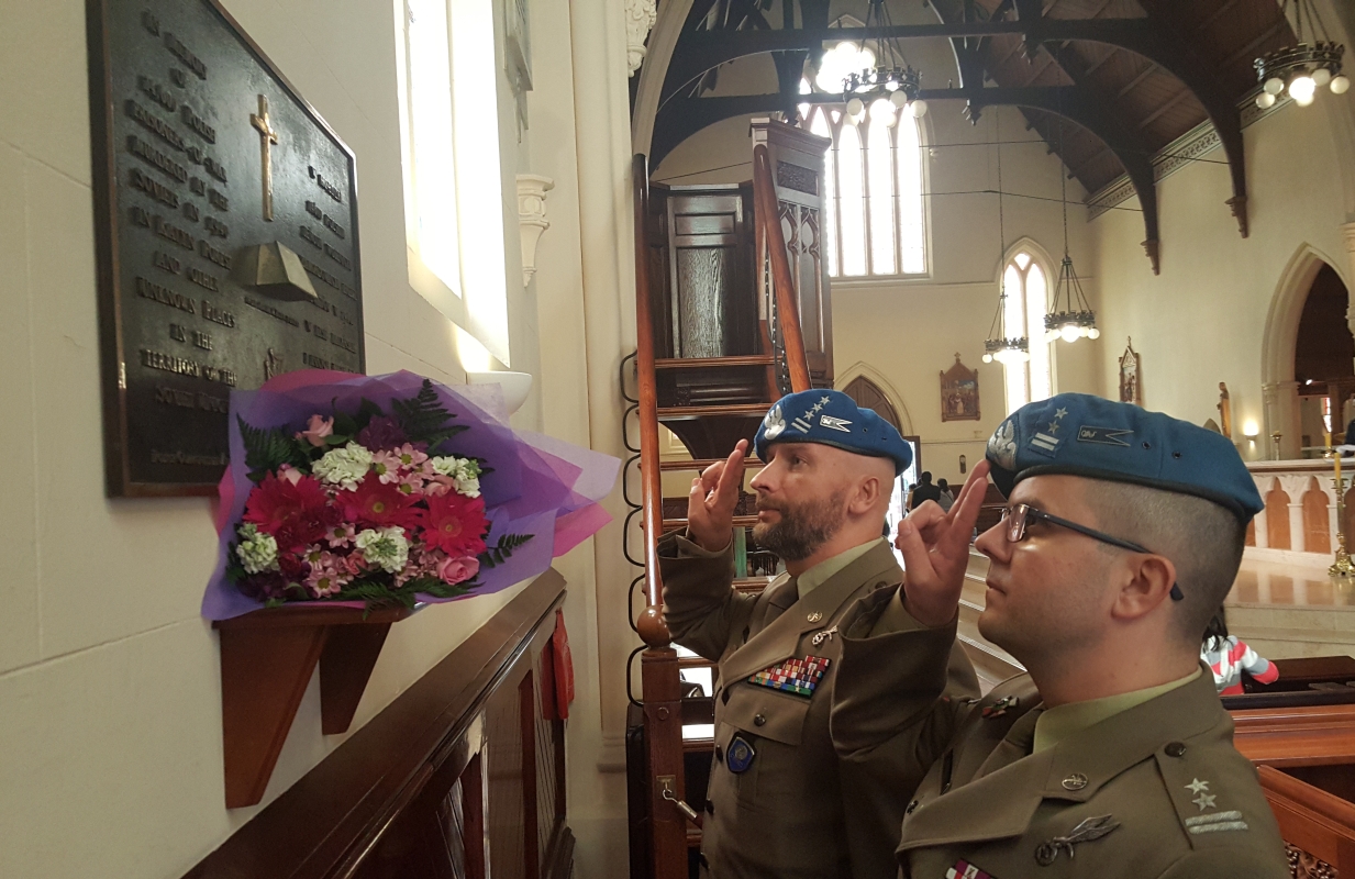 Inside the cathedral, close-up 
of the two soldiers saluting