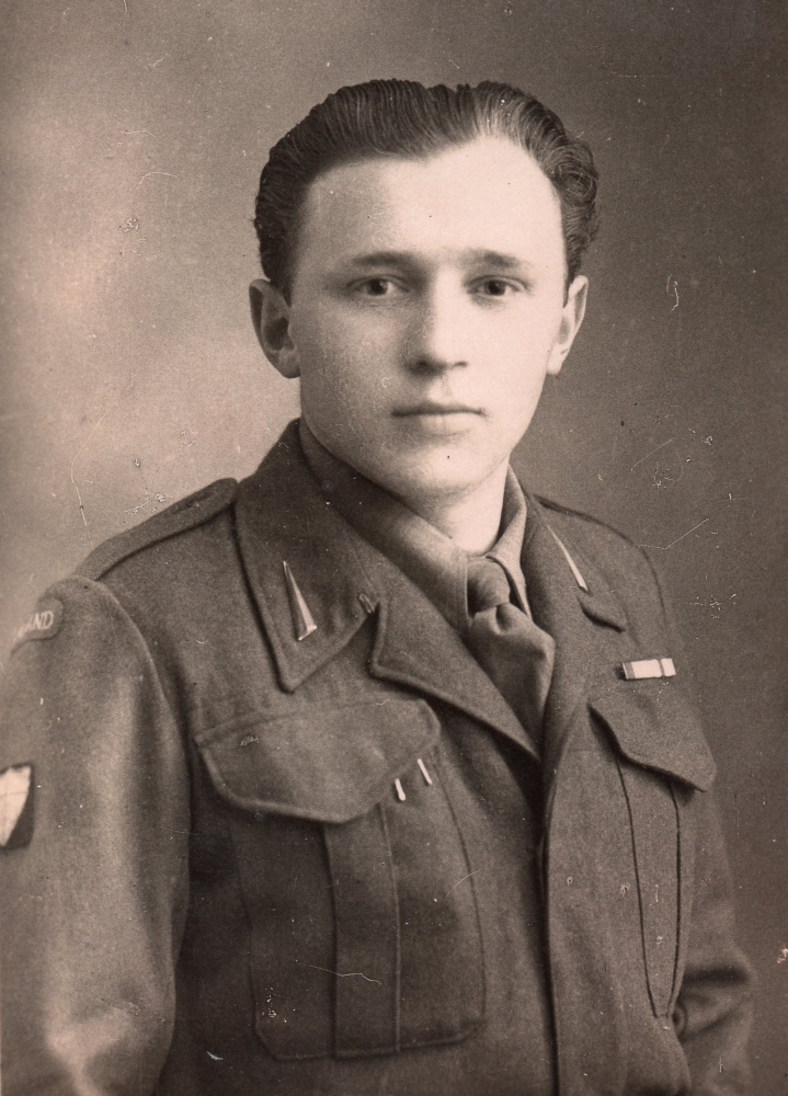 A studio 
photograph of a bare-headed Piotr in military uniform.