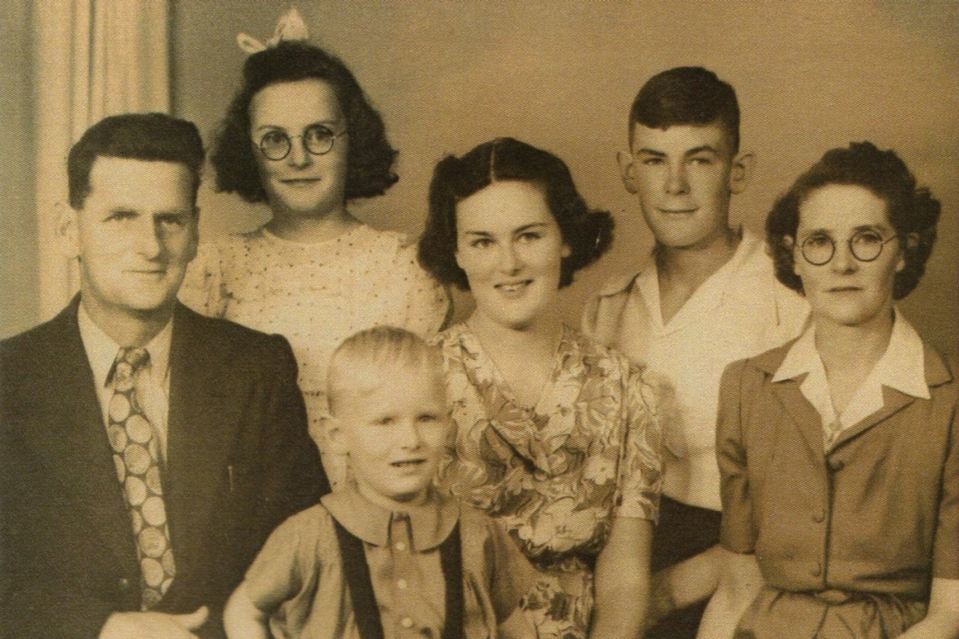 A blurry studio 
photo of Con, Edna and their four children.