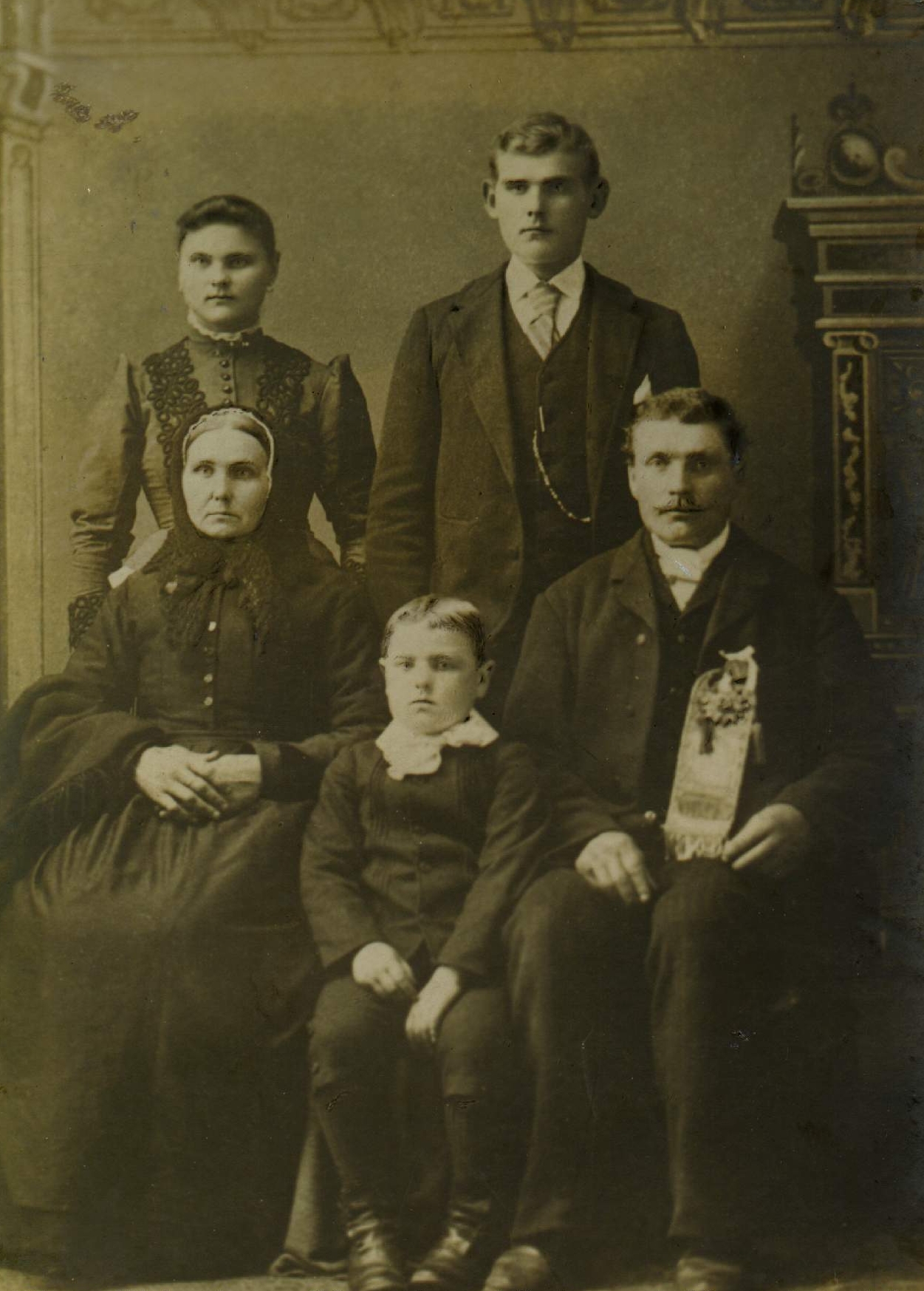 A studio photograph of Johann and Francizka, 
seated with Michael as a young boy between them and Mary and Joseph standing behind them.