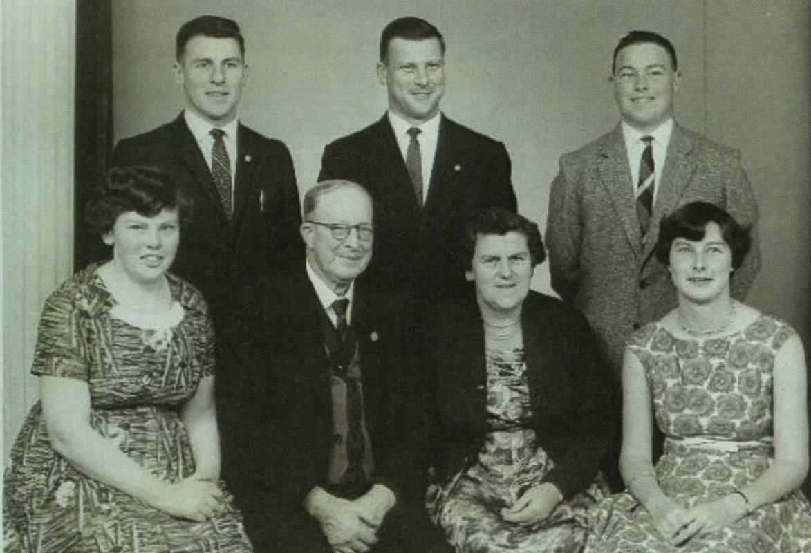 A blurry studio 
photo of Mona and John Hartley and their adolescent and adult children.