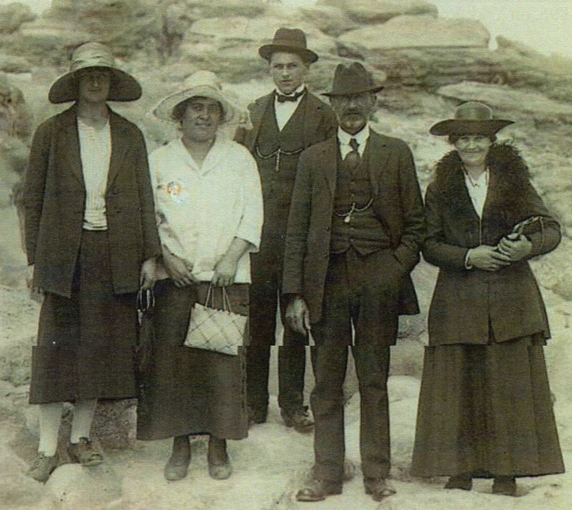 Mary and August 
Uhlenberg with two adult children and a woman guide in front of a rocy outcrop.