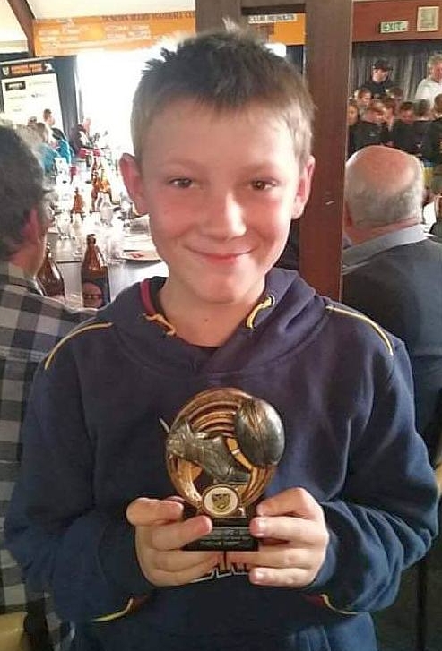 Thomas Kreft smiling 
with his Most Improved Player award