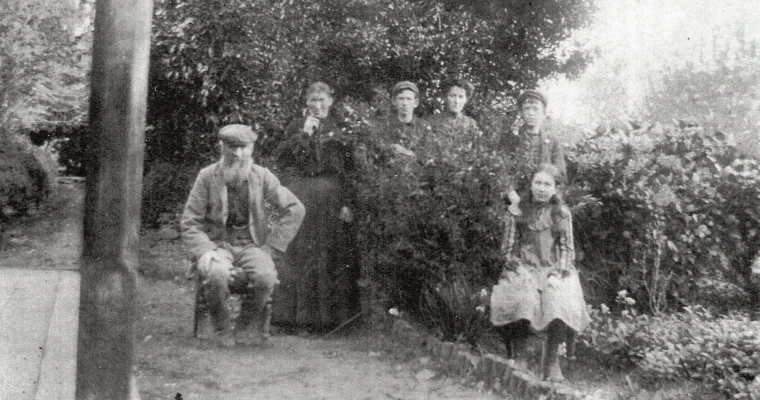 Black and white 
photograph of the family. Jacob senior is seated and Mary is standing on the left, and the four children are in the 
flowerbed, the three oldest behind a shrub and Kate on a chair in front.