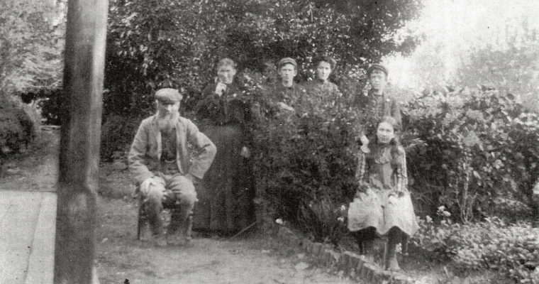 Black and white 
photograph of the family. Jacob senior is seated and Mary is standing on the left, and the four children are in the 
flowerbed, the three oldest behind a shrub and Kate on a chair in front.