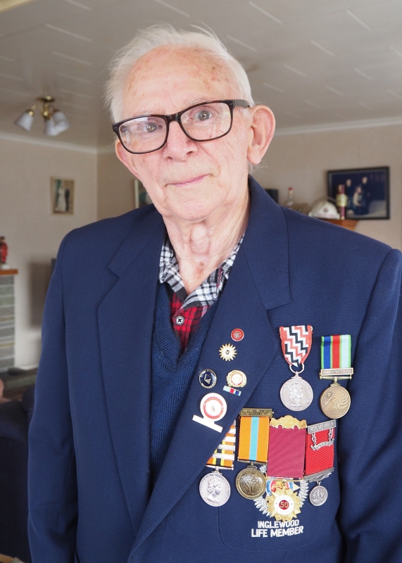 2019 photograph of 
Joe, wearing his Inglewood Fire Service Life Member jacket, with his six fire-service medals and numerous lapel pins.