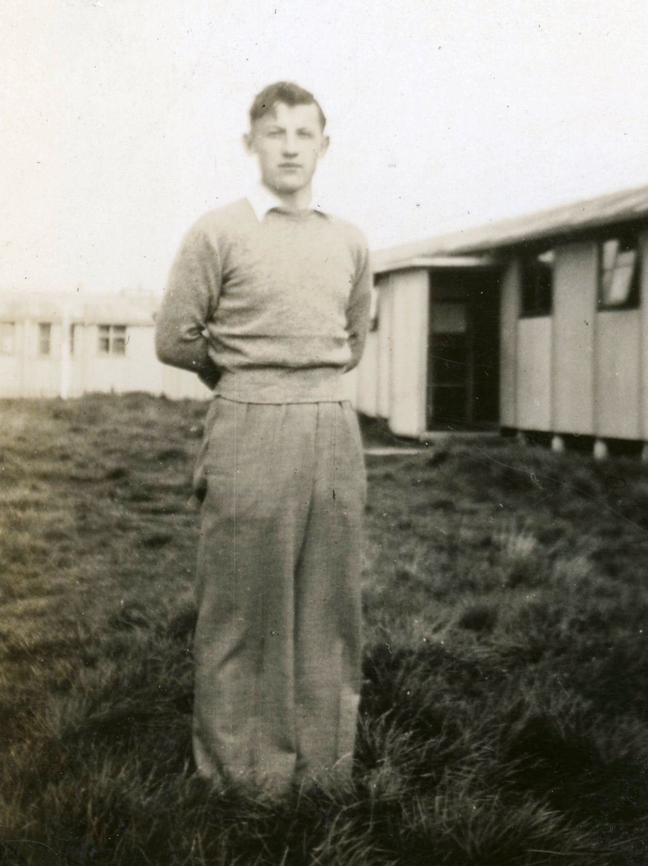 Jan 
Jarka stands in the grass outside some buildings at Pahiatua