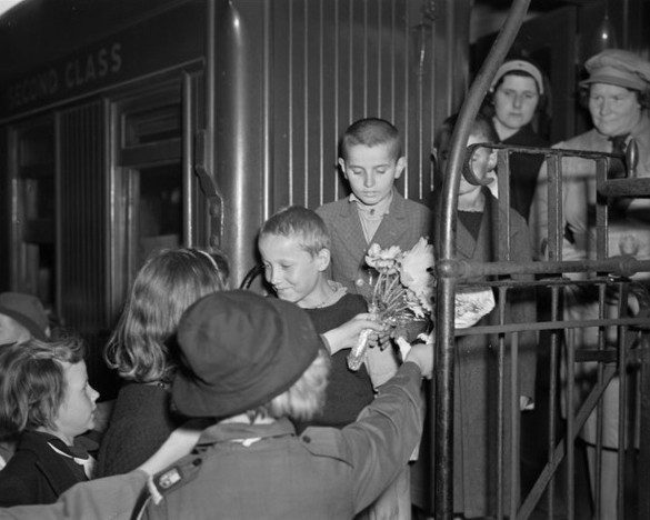 Some of the 
Polish children on the train steps being greeted by Palmerston North children holding flowers