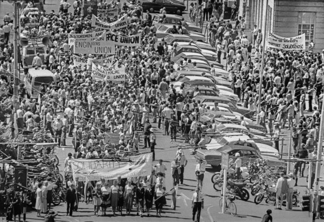 Hundreds of people with trade union banners in a Wellington street