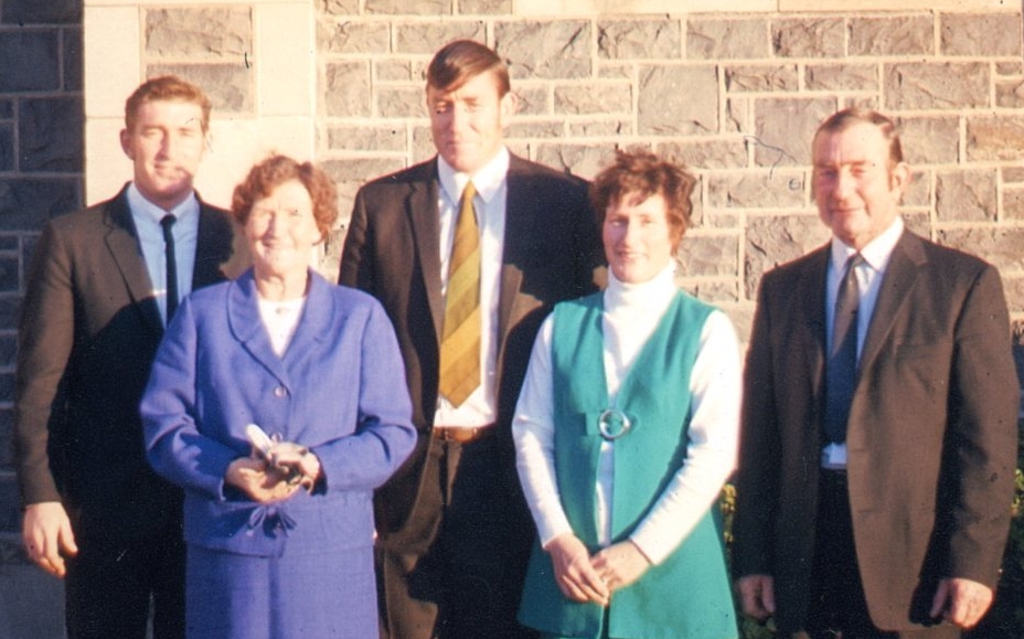 The adult Alexander 
family outside what looks like a church