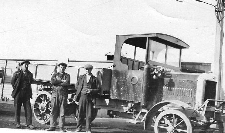 Ken 
Luskie, middle, with other employees in front of tram