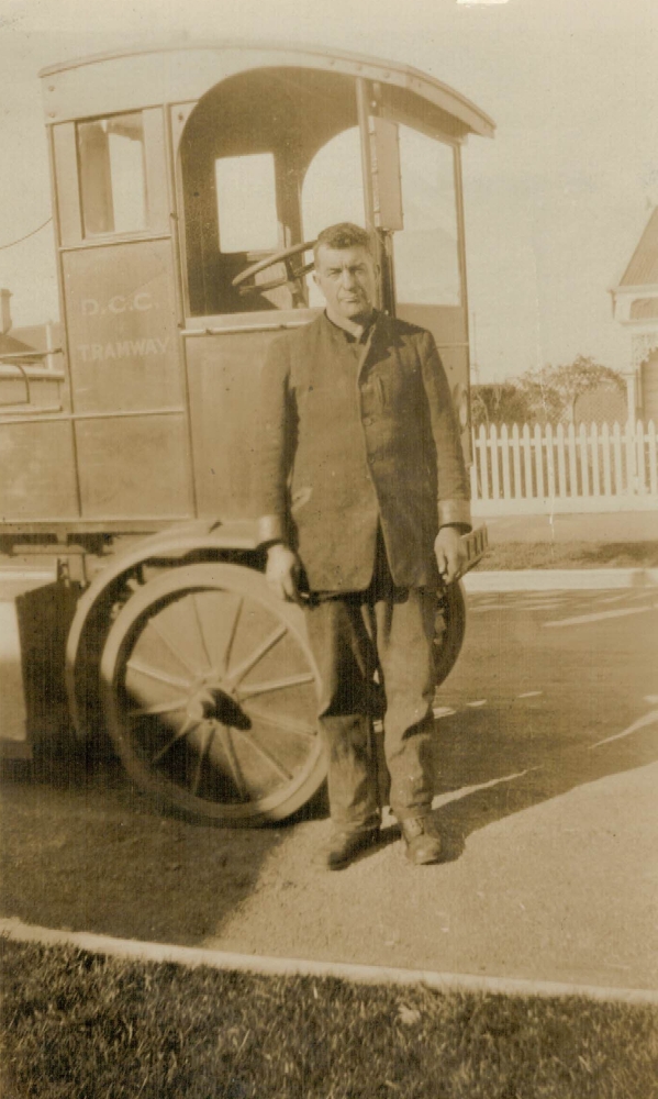 Bert Luskie next to his   
tram