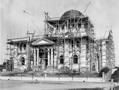 Black & white image of the cathedral with scaffolding, showing front central dome