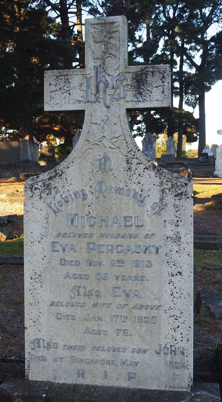 The 
Percasky headstone, with its back to the sun, so tough to read. Other headstones in the background 