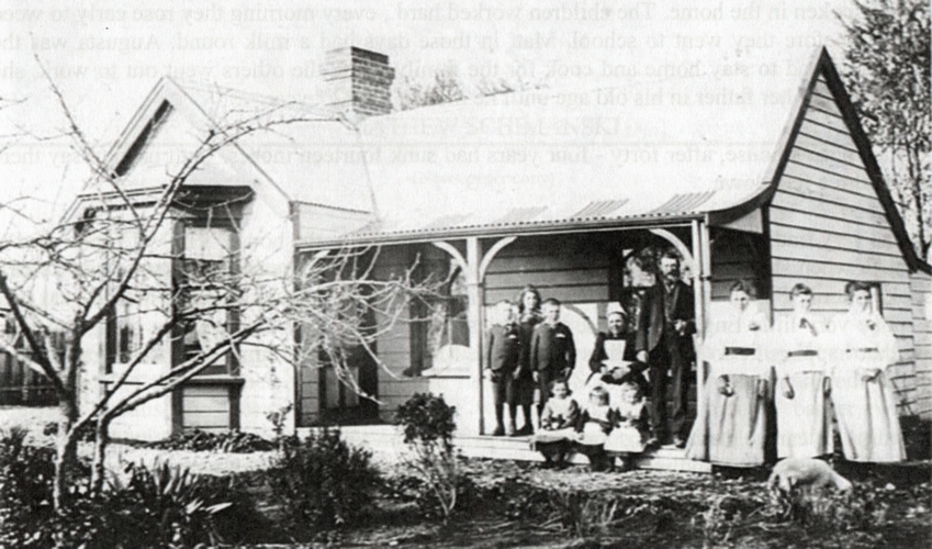The family in Sunday 
best attire on and in front of the veranda of their home. The children are in groups of three, with the three youngest in 
front of their parents in the middle.