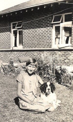 Gertrude Orlowski sitting with the dog in the back garden