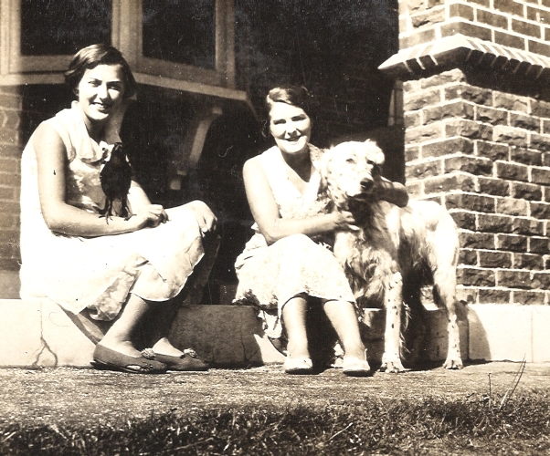 Gerturude and Mavis Orlowski on house steps with magpie and dog