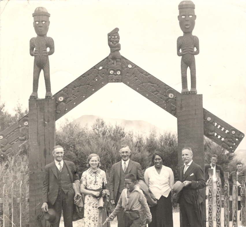 John Andrew and Madeline with others in front of Maori arch