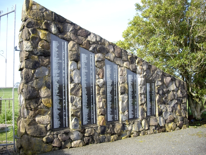 The triangular stone entrance at the Midhirst Old cemetery, showing five plaques of names, the plaques becoming smaller 
the farther from the gate they are.