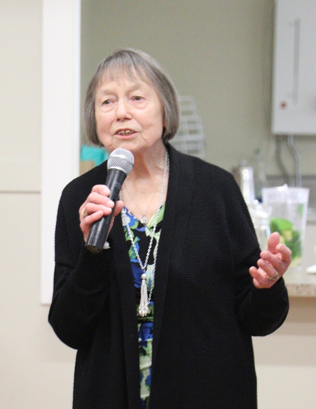 Pani Henia with a microphone in her hand, singing. 